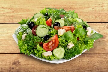 Fresh spring vegetable salad with tomatoes and peppers in the bowl.