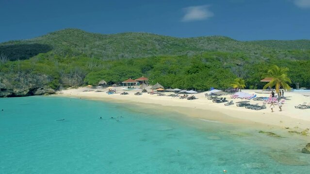 View of the white beach Grote Knip, Curacao, Netherlands with a blue ocean Curacao Caribbean Island tropical beach with palm trees