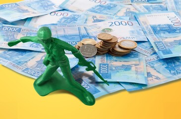 Miniature of soldier on Russian money: financing of war and aggressive actions.