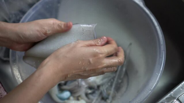 Hand Washing Raw Squid With Salt Preparing Food In Kitchen Sink