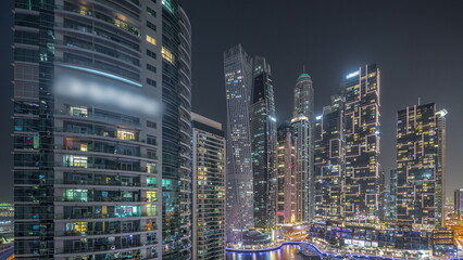 Obraz na płótnie Canvas Dubai marina tallest skyscrapers and yachts in harbor aerial night timelapse.