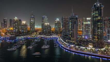 Luxury yacht bay in the city aerial night timelapse in Dubai marina