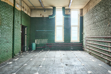 Old abandoned brick building with green walls