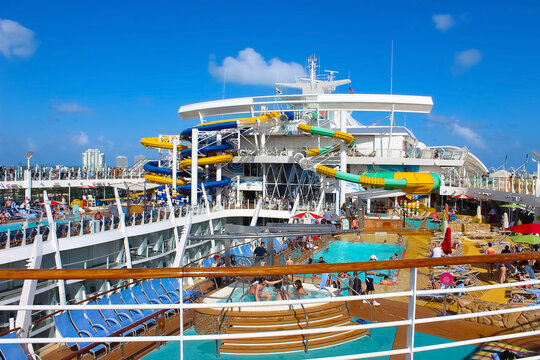 Miami, USA - April 29, 2022: People having fun at pools, bars, entertainment and innovative activities at Symphony of the seas is the biggest cruise ship at Miami, USA on April 29, 2022