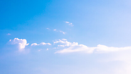 Blue sky background with white tiny clouds.