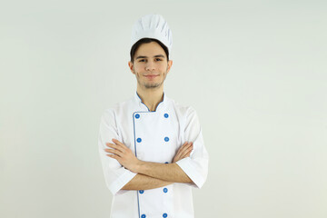 Concept of cooking, young man chef on light background