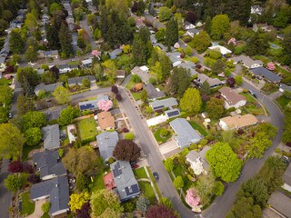 Shooting from a drone. Picturesque small town with developed infrastructure. Roofs of one-story...