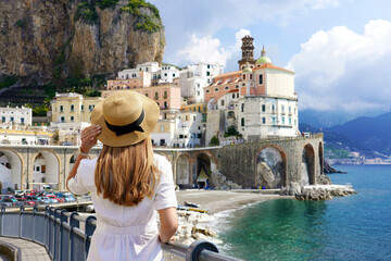 Beautiful Italy. Back view of tourist girl exploring amazing Amalfi Coast, Italy.