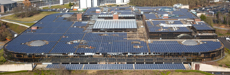 Large building with many solar panels on the roof