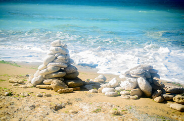 Pile of stone on the beach on the lighthouse Phare des Baleines on the isle of Ile de Ré in France on a sunny summerday
