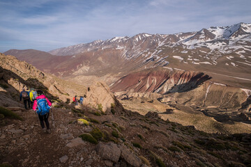 walkers descending to the Tarkeddit plain, M Goun trek, Atlas mountain range, morocco, africa
