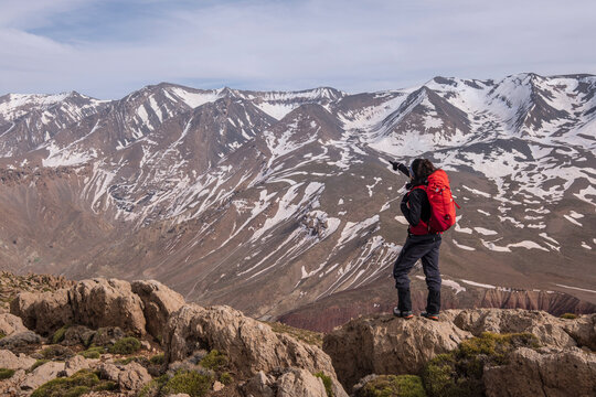 woman hiker on Aghouri ridge observing the M Goun mountain range, 4068mts, Atlas mountain range, morocco, africa
