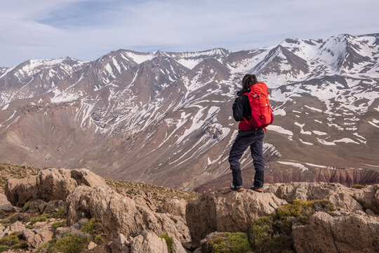 woman hiker on Aghouri ridge observing the M Goun mountain range, 4068mts, Atlas mountain range, morocco, africa