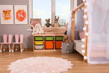 Stylish child room interior with comfortable house bed