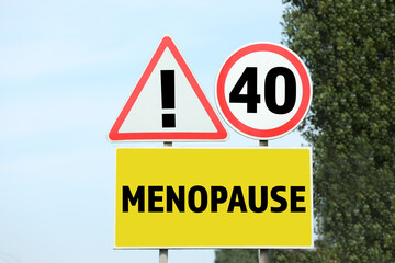 Concept of impending menopause at 40 years old. Post with dIfferent signs outdoors