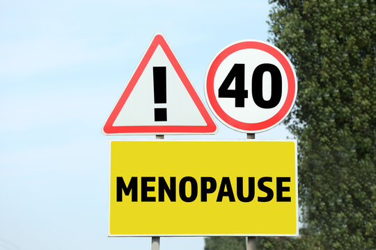 Concept Of Impending Menopause At 40 Years Old. Post With DIfferent Signs Outdoors