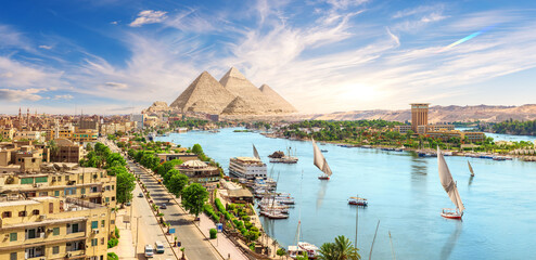 Aswan downtown with sailboats, panoramic view on the Nile, Egypt - obrazy, fototapety, plakaty