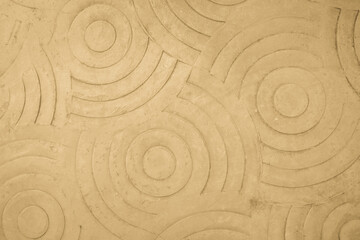 Fototapeta na wymiar Abstract cream paint floor stamped concrete surface on walkway in garden. Wallpaper pattern curved circle cement.