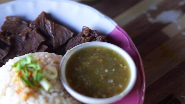 
Buffalo meat with rice. The meat is stewed and topped with rice
