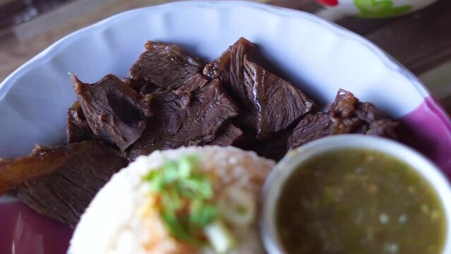 
Buffalo meat with rice. The meat is stewed and topped with rice
