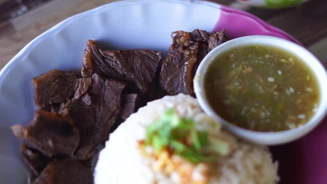 
Buffalo meat with rice. The meat is stewed and topped with rice
