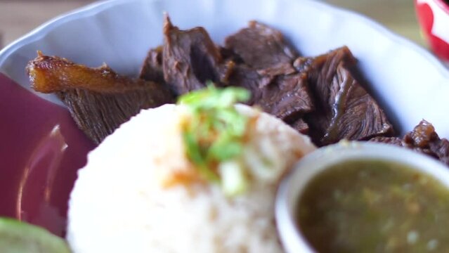 
Buffalo meat with rice. The meat is stewed and topped with rice
