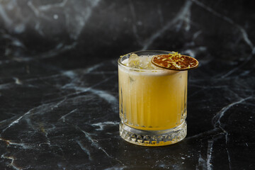 Fruit mixology with mezcal and dry lime on black marble background. Warm colored cocktails. Mezcal...
