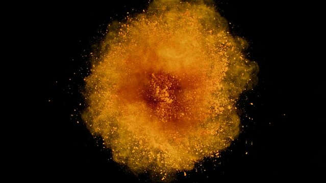 Super Slow Motion Shot of Rotating Orange Powder Expolosion Isolated on Black Background at 1000fps.