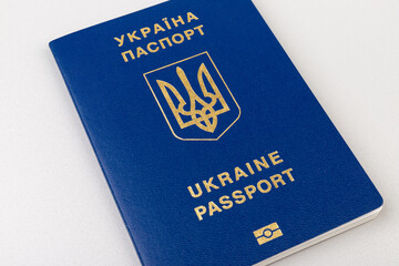 Ukrainian passport with a golden trident symbol on light background. Biometric Ukraine passport id...