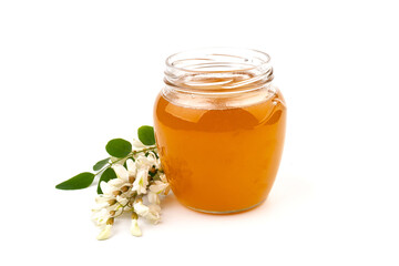 Jar of honey with flowers of acacia isolated on white background