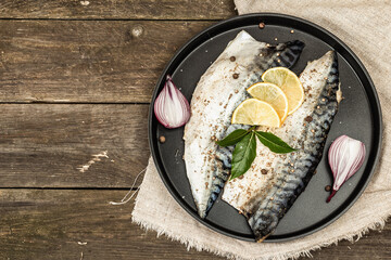 Marinated mackerel with spices and fresh bay leaves. Healthy food, ready to eat, served with lemon