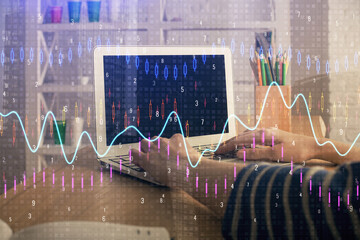 Double exposure of woman hands typing on computer and forex chart hologram drawing. Stock market...