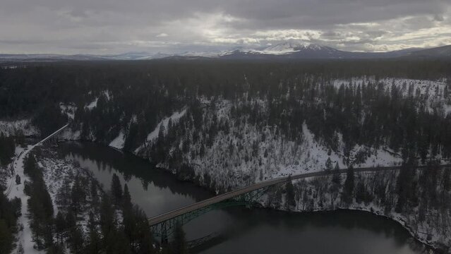 Car crossing a bridge in the winter near Yellowstone National Park.