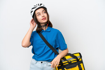 Young Ukrainian woman with thermal backpack isolated on white background thinking an idea