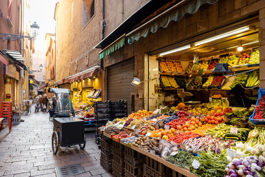 Gastronomical street with market stalls full of fresh local fruits and vegetables in Bologna, Italu
