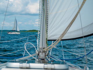 Obraz premium view on a a sailing yacht from the bow of a sailing boat or yacht
