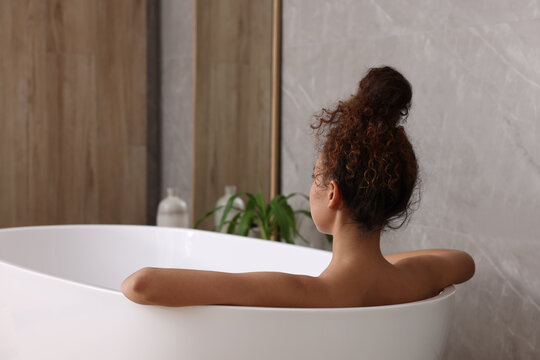 African American Woman Taking Bath Indoors, Back View. Space For Text