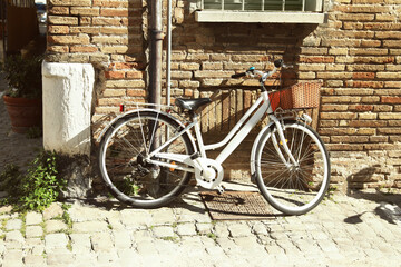 Fototapeta na wymiar Bicycle with basket near building on sunny day