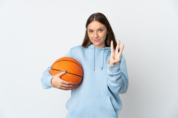 Young Lithuanian woman playing basketball isolated on white background happy and counting three with fingers