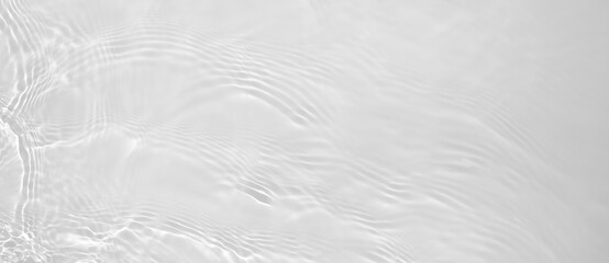 Abstract summer banner background Transparent beige clear water surface texture with ripples and splashes. Water waves in sunlight, copy space, top view. Cosmetics moisturizer micellar toner emulsion