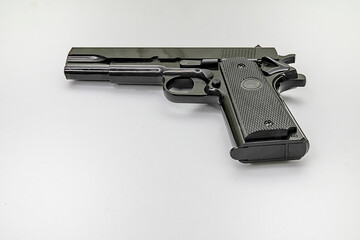Handgun. Isolated. Black handgun side view flat on a white background. Copy Space. Stock Image.