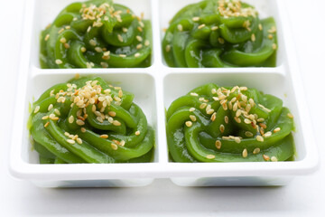 Sweet pandan pudding with white sesame seeds