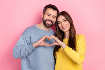 Photo of two idyllic peaceful people hands fingers demonstrate heart symbol isolated on pink color...