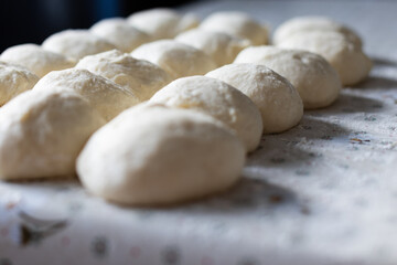Fototapeta na wymiar Balls from the dough for pies. Baking at home. Selective focus.