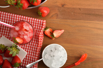 Fruit granita with ripe strawberries of ice on table top