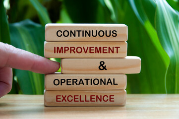 Continuous improvement and operational excellence text on wooden blocks. Business Concept - obrazy, fototapety, plakaty