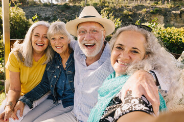 Excited senior friends taking a selfie together during vacation