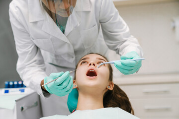 Black dentist working with patient in dental clinic