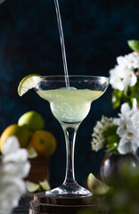 margarita glass is full of drink. margarita cocktail is on the table.