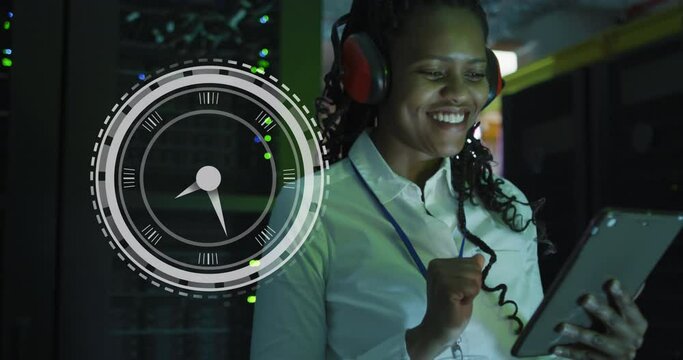 Animation of clock over happy african american wpman working on tablet
